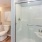 a bathroom with a shower unit and toilet