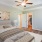 a bedroom with a bed and a fan