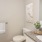a bathroom with a sink toilet and a plant