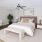a bedroom with a bed and a chair