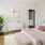 a room with a bed and a plant